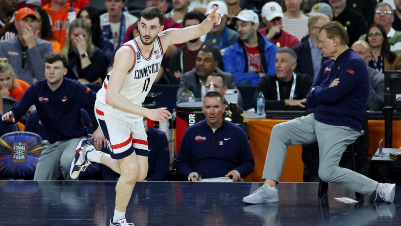 UConn Huskies forward Alex Karaban celebrates a three