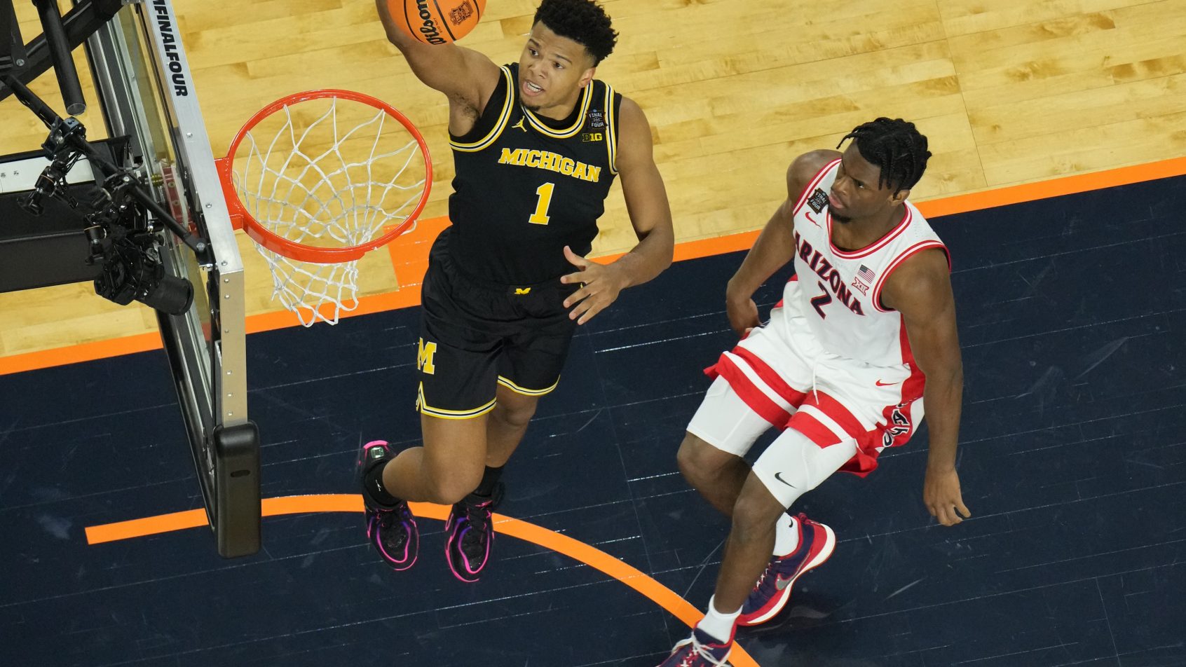 Michigan Wolverines guard Trey McKenney lays the ball in the hoop