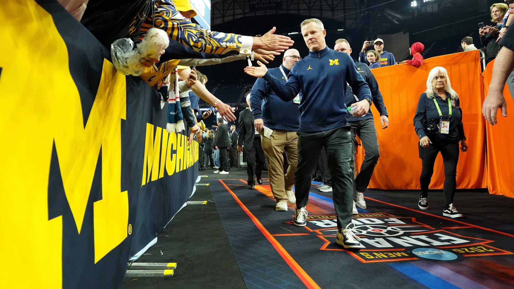 Michigan Wolverines head coach Dusty May high-fiving fans