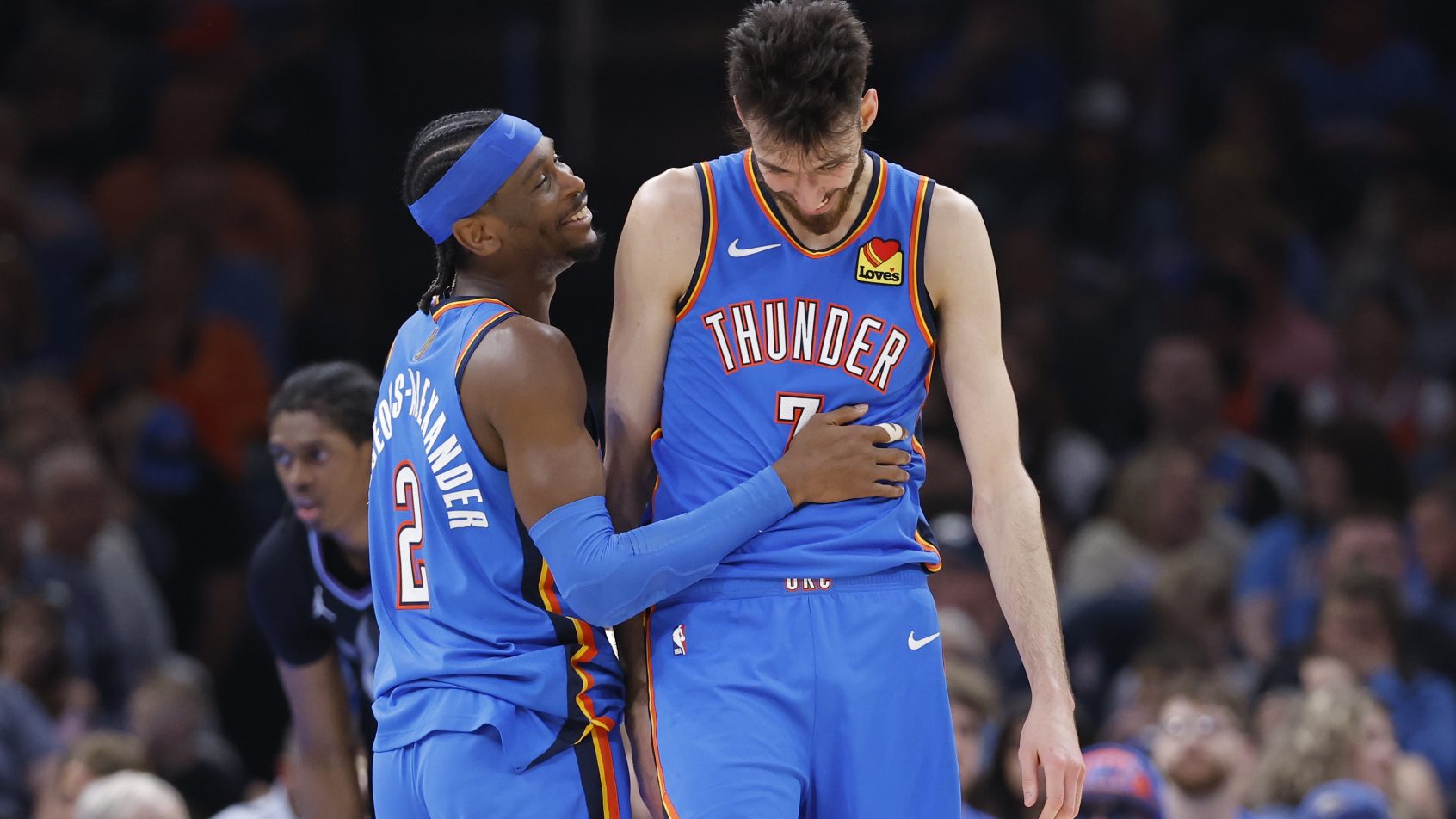 Shai-Gilgeous Alexander shares a laugh with Chet Holmgren in a game versus the Jazz.