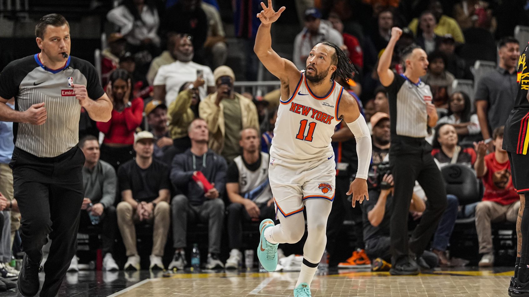 Jalen Brunson celebrates after splashing a three-pointer versus the Celtics.