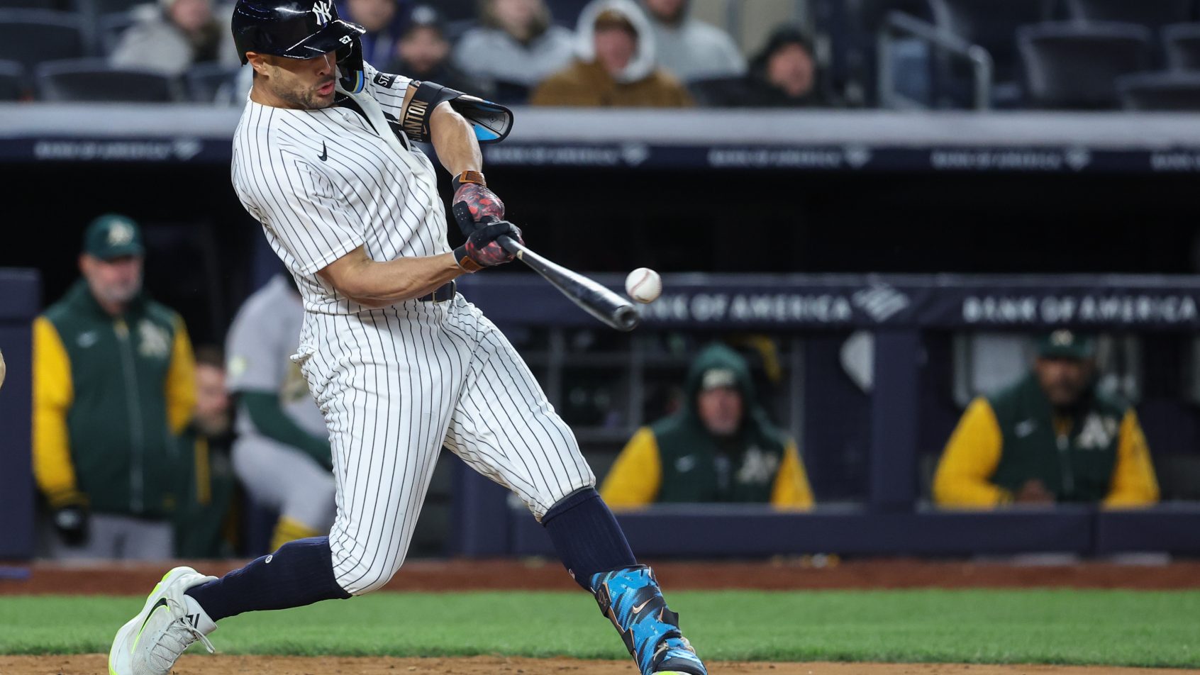 New York Yankees designated hitter Giancarlo Stanton hits an RBI single in the eighth inning against the Athletics.