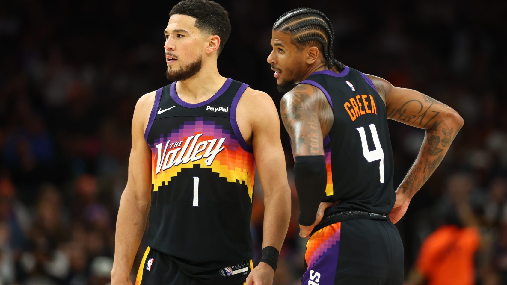 Devin Booker and Jalen Green look on in a matchup versus the Rockets.