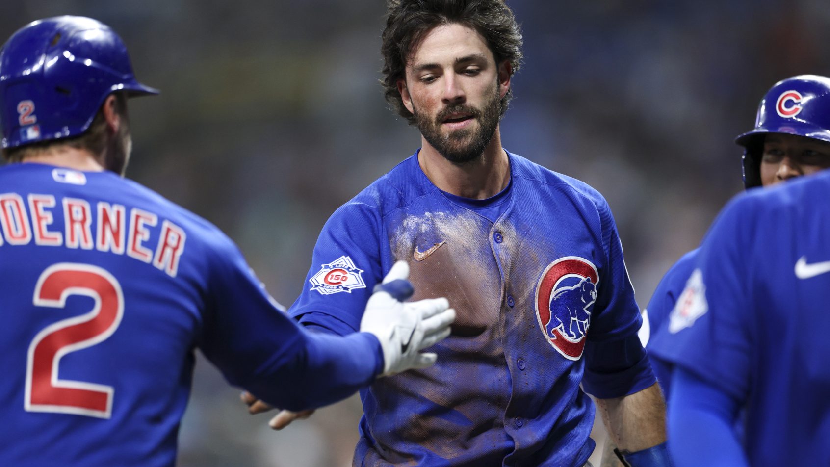 Chicago Cubs shortstop Dansby Swanson is congratulated at home plate