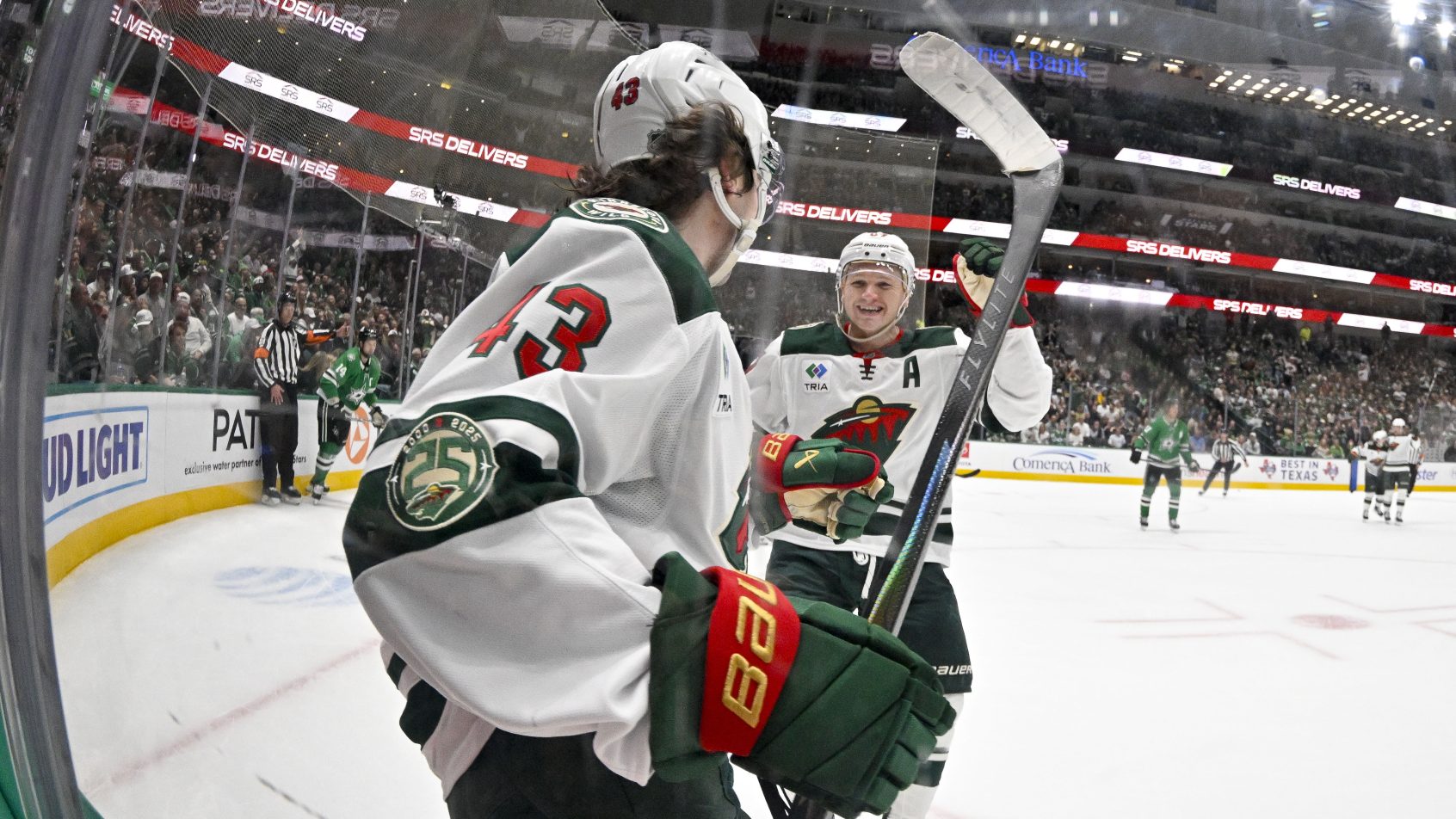 Quinn Hughes and Kirill Kaprizov celebrate a goal versus the Stars.
