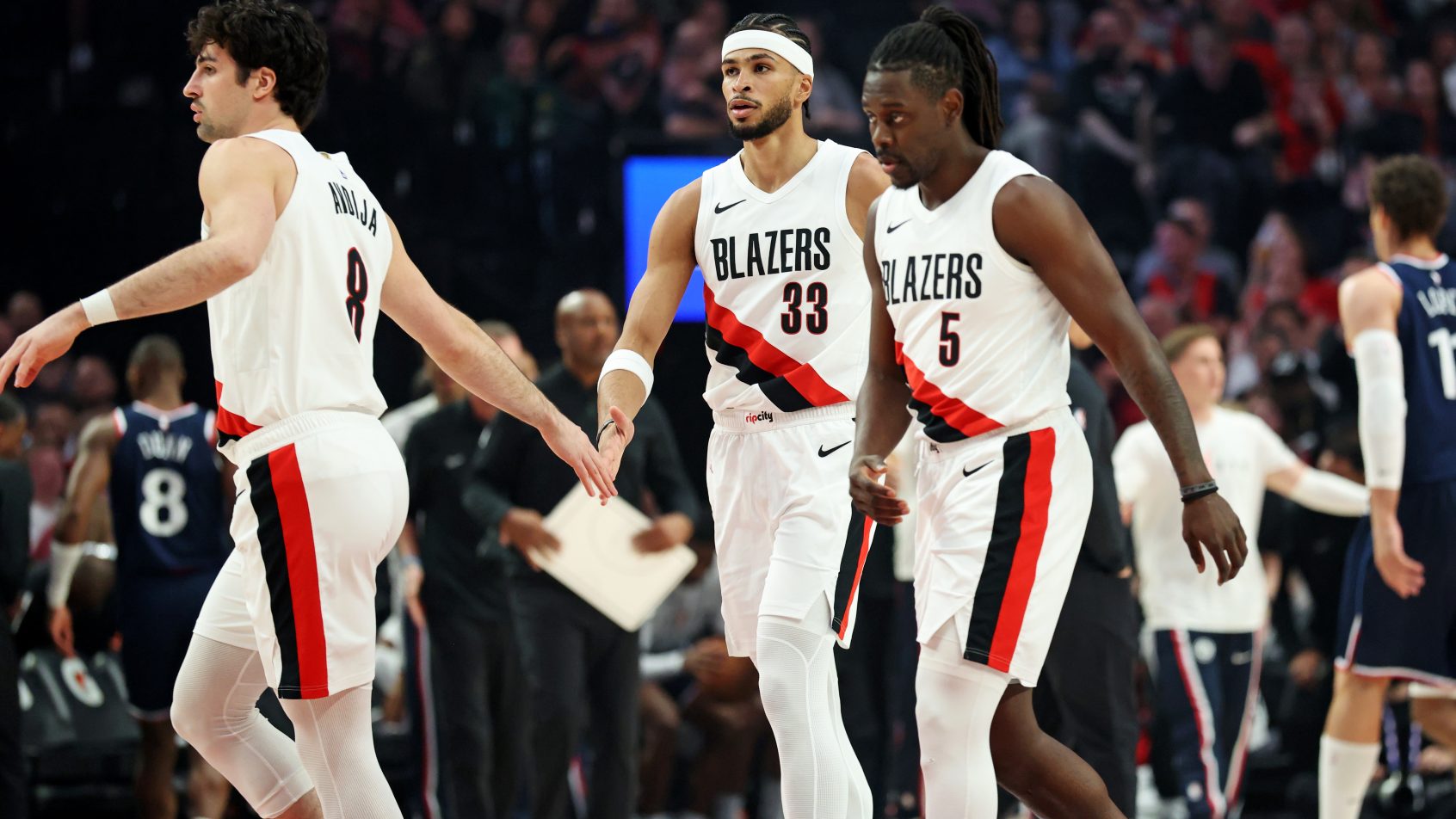 Blazers high-fives as they head back to the bench during a timeout in a game versus the Clippers.