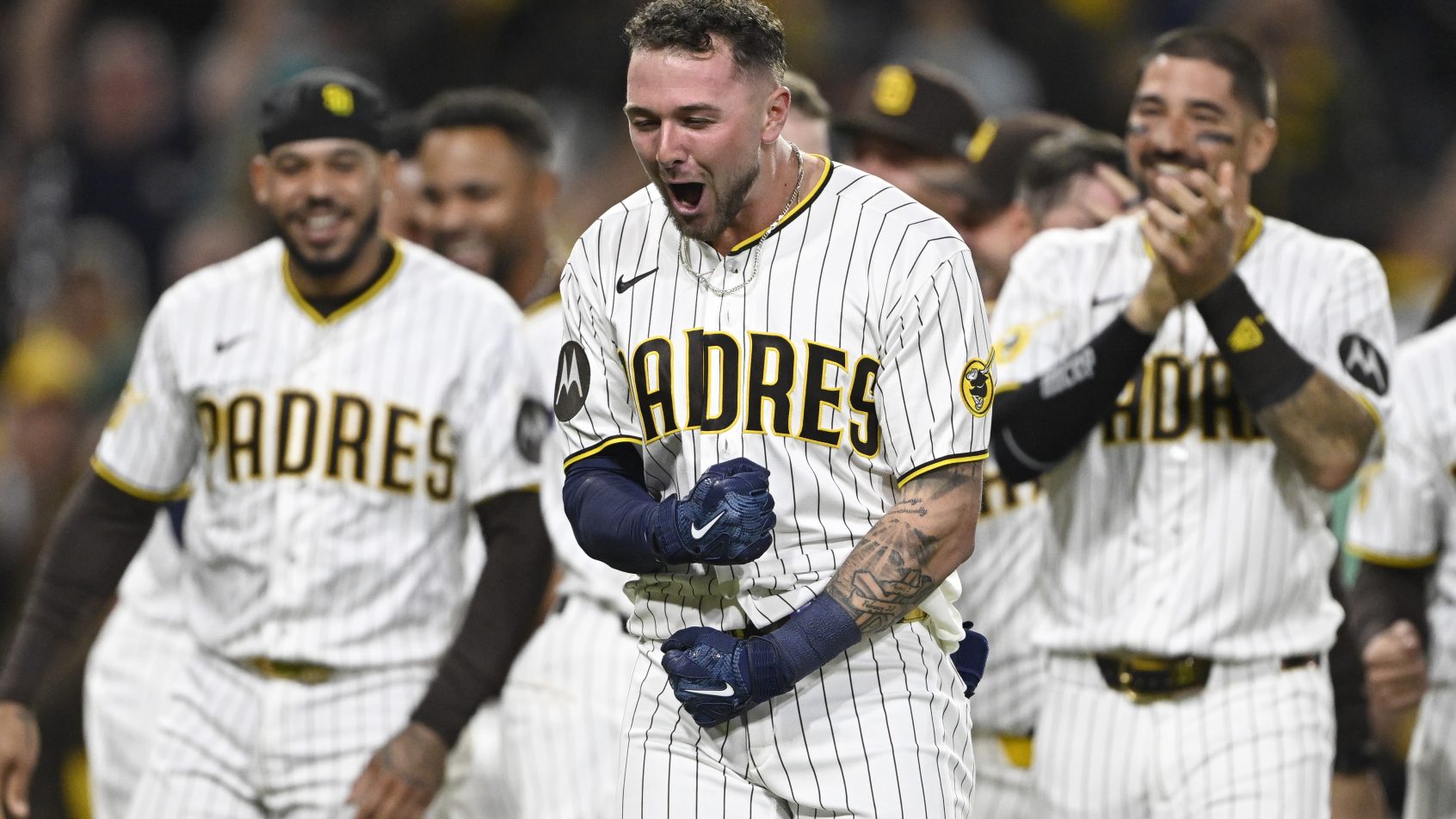 The Padres celebrate a walk-off victory over the Mariners.