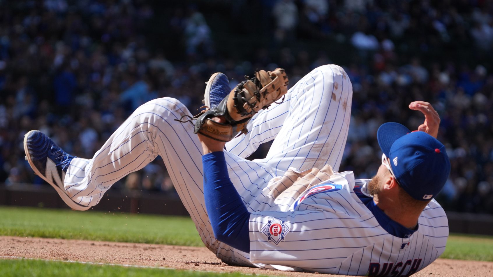 Chicago Cubs first baseman Michael Busch on his back