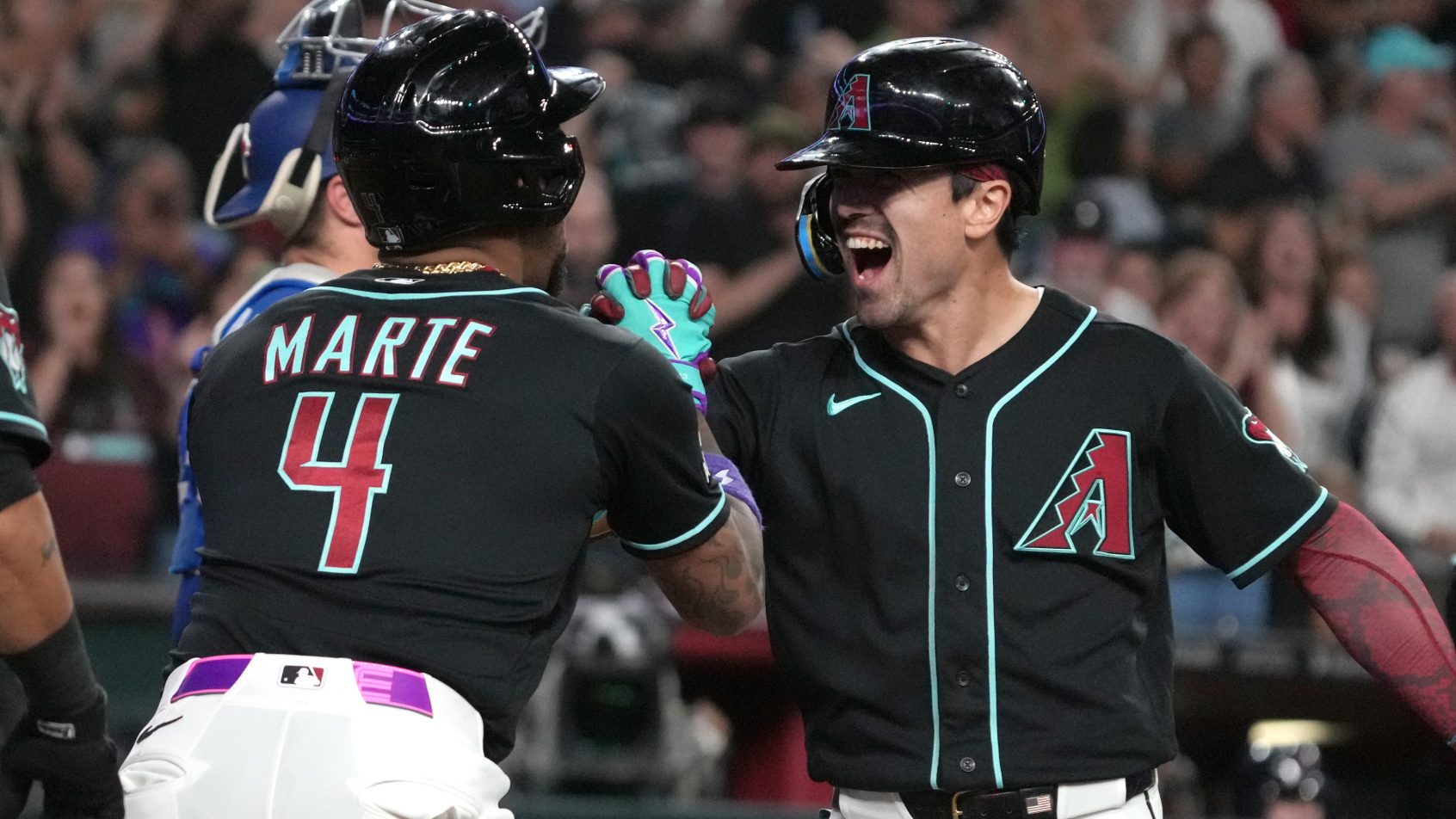 Corbin Carroll and Ketel Marte celebrate a run versus the Blue Jays.