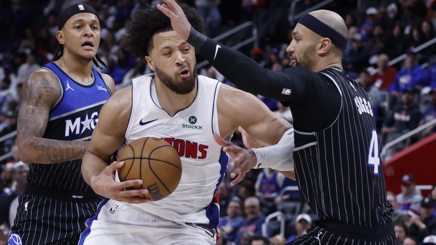 Cade Cunningham drives to the hoop versus Jalen Suggs.
