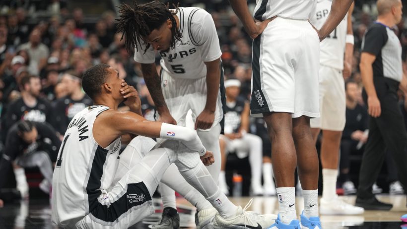 San Antonio Spurs forward Victor Wembanyama sitting on the floor