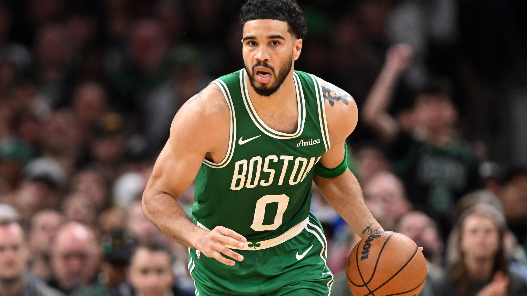 Jayston Tatum brings the ball up court versus the 76ers.