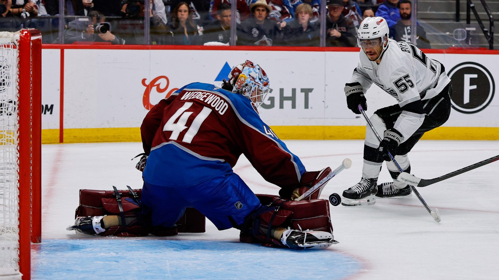 Scott Wedgewood stops Quinton Byfield in tight.