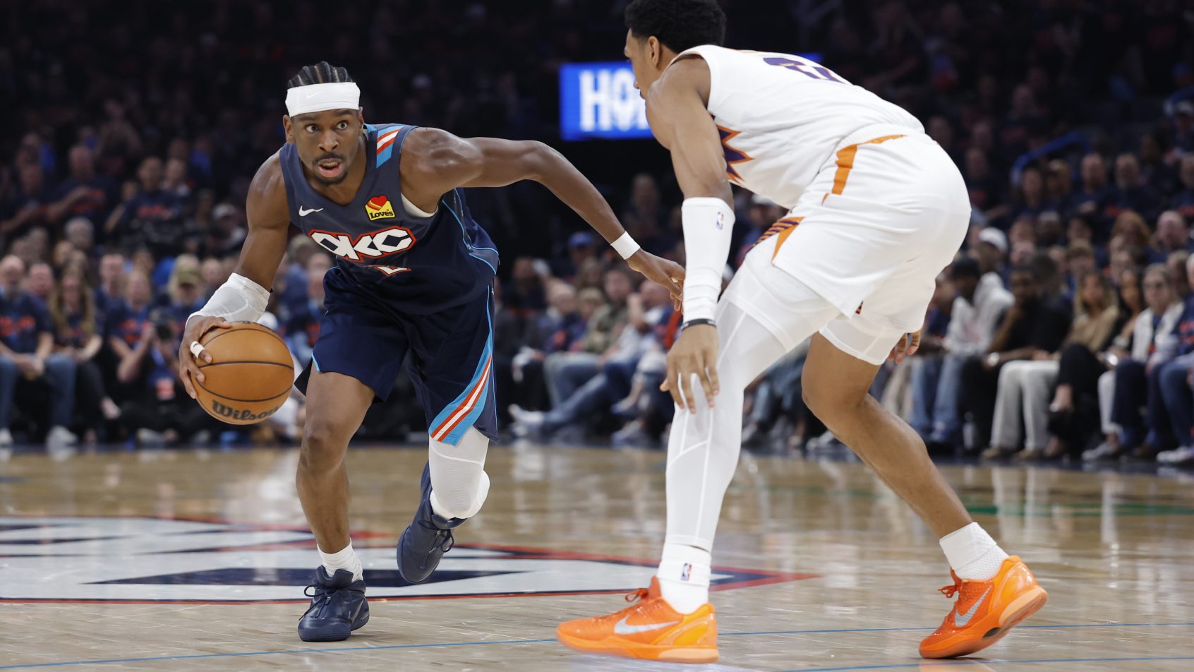 Shai Gilgeous-Alexander driving by opponent