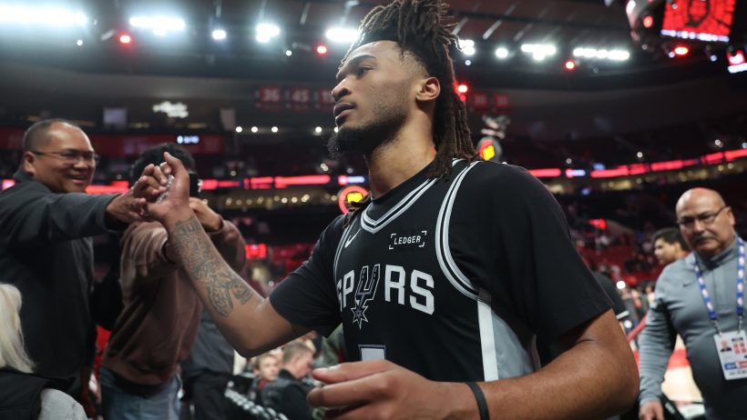 Stephon Castle high fives fans after a Spurs Game 3 victory over the Blazers.