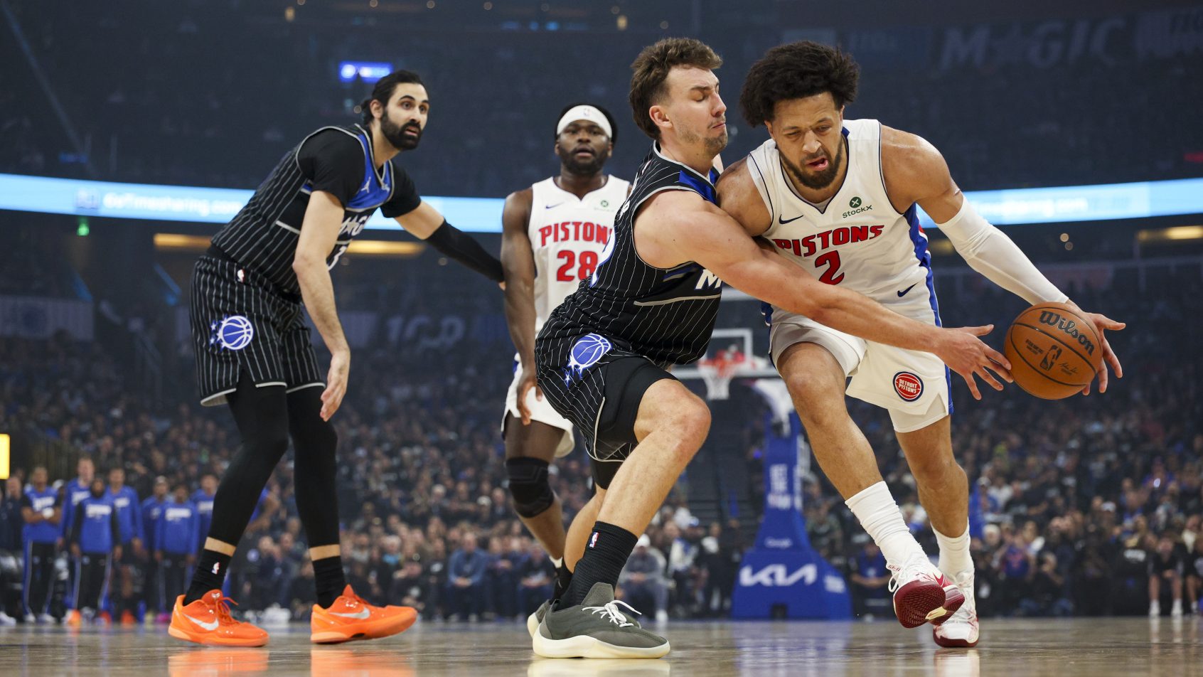 Franz Wagner reaches in to knock the ball away from Cade Cunningham.