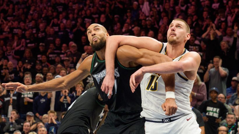 Rudy Gobert and Nikola Jokic battle for a rebound.