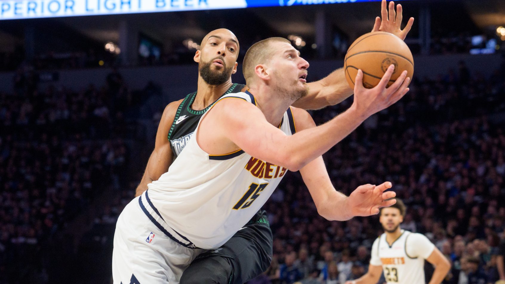 Nikola Jokic gets around Rudy Gobert on his way to the basket.