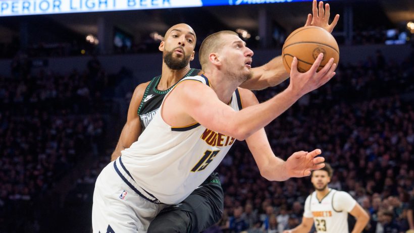 Nikola Jokic gets around Rudy Gobert on his way to the basket.