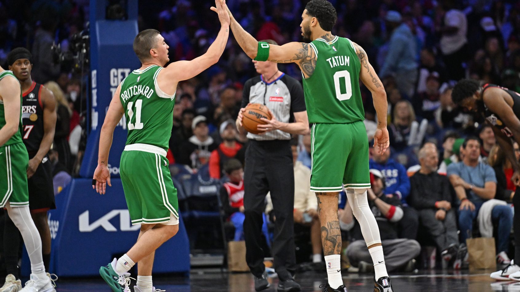 Jayson Tatum high-fives his teammate after a bucket versus the 76ers.