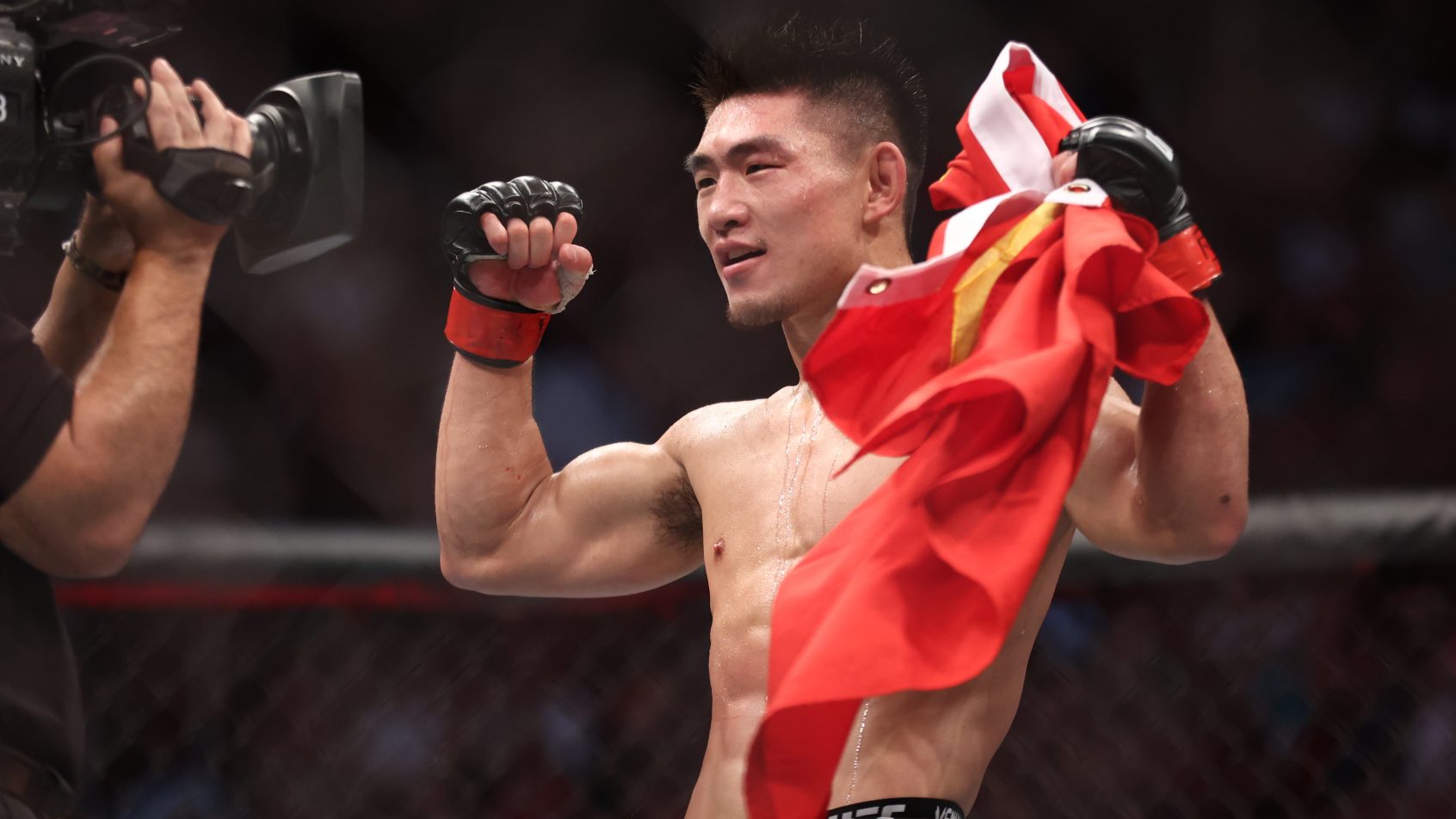 Aug 7, 2021; Houston, Texas, USA; Song Yadong (red gloves) reacts to fight against Casey Kenney (blue gloves) during UFC 265 at Toyota Center. Mandatory Credit: Troy Taormina-Imagn Images