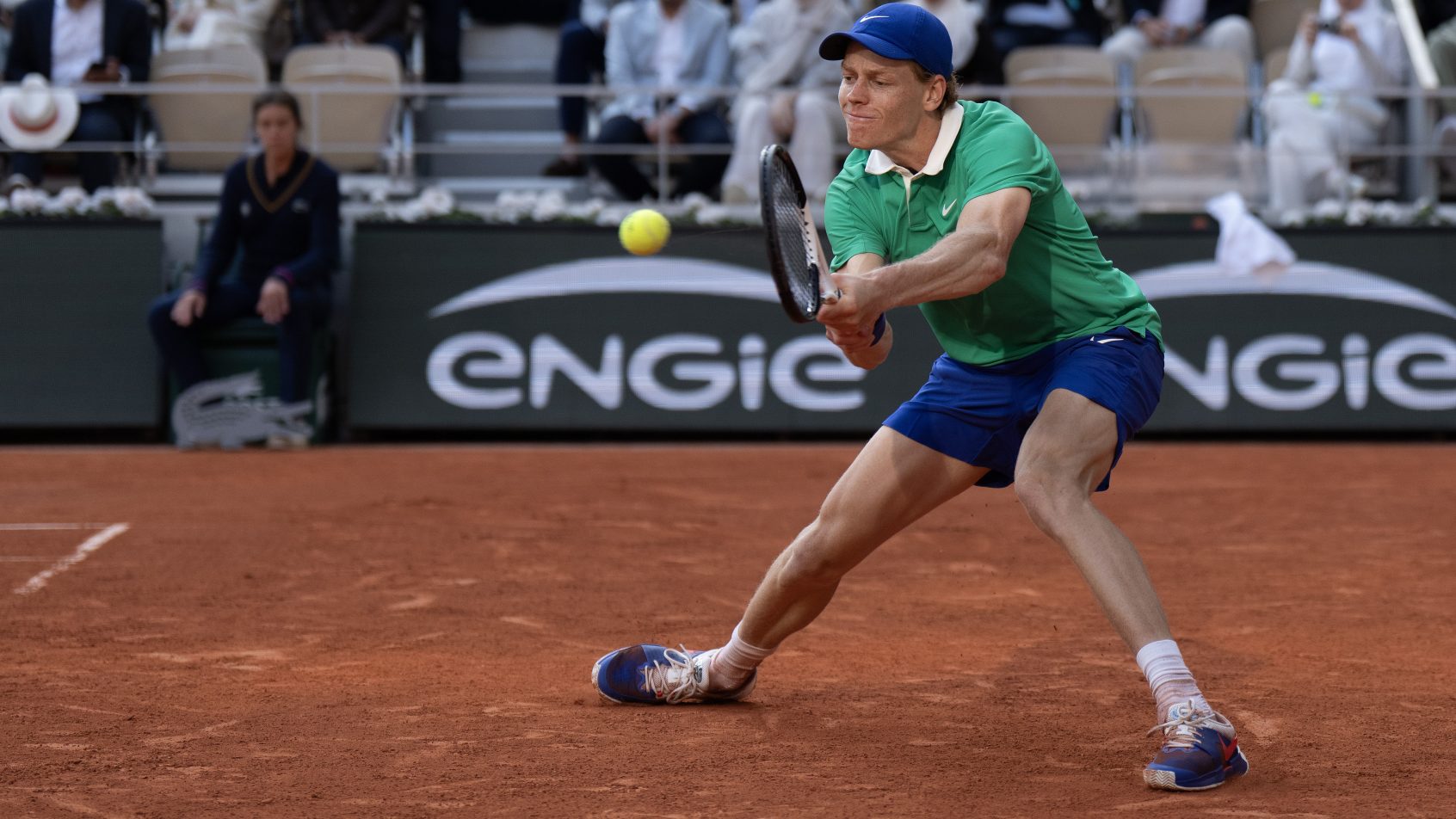 Jannik Sinner stretches to hit a backhand