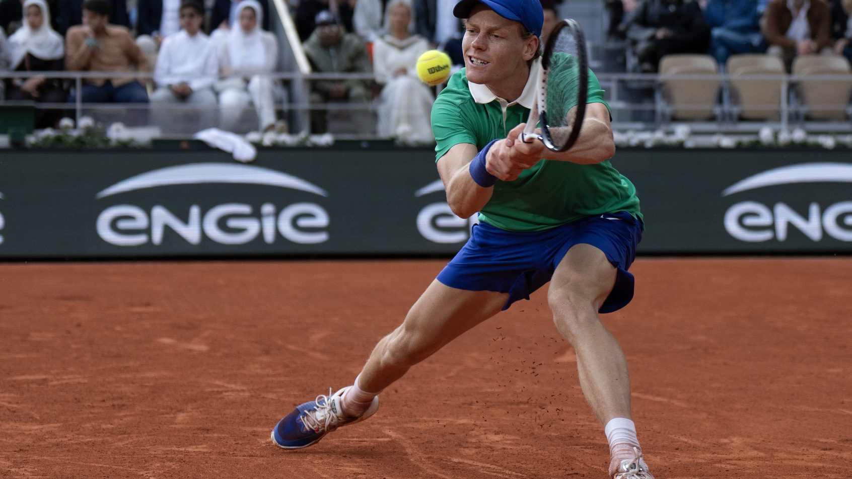 Jannik Sinner stretches to hit a backhand