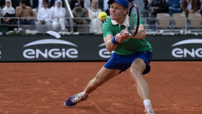 Jannik Sinner stretches to hit a backhand