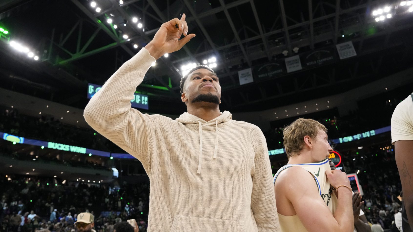 Giannis Antetokounmpo on the sidelines during a Bucks game.