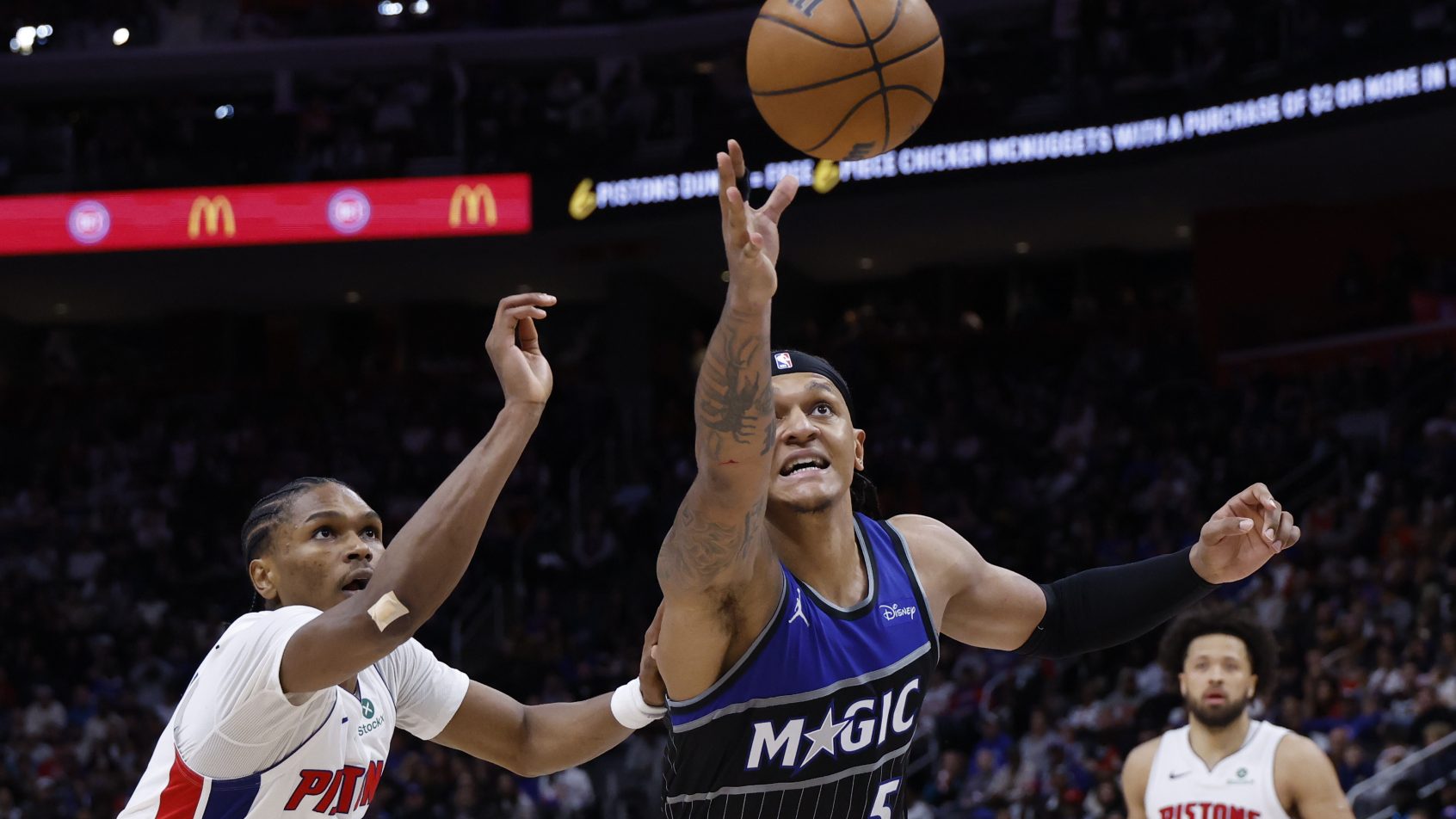 Paolo Banchero fights for a loose ball versus the Pistons.