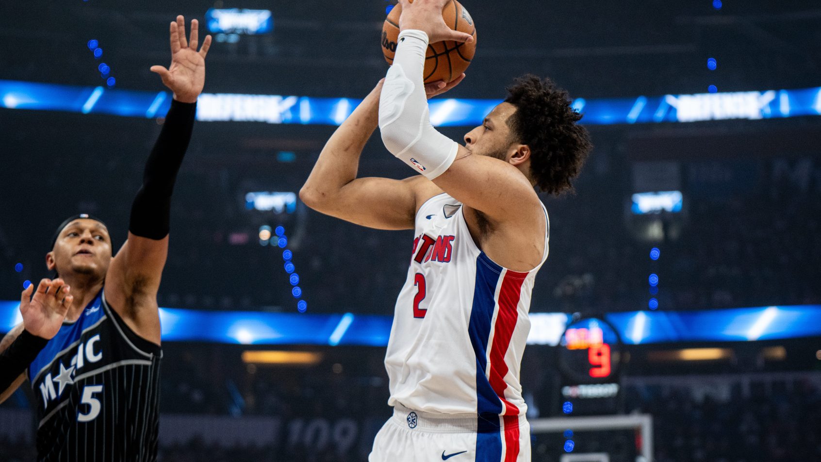 Cade Cunningham rises up and shoots over an Orlando defender.