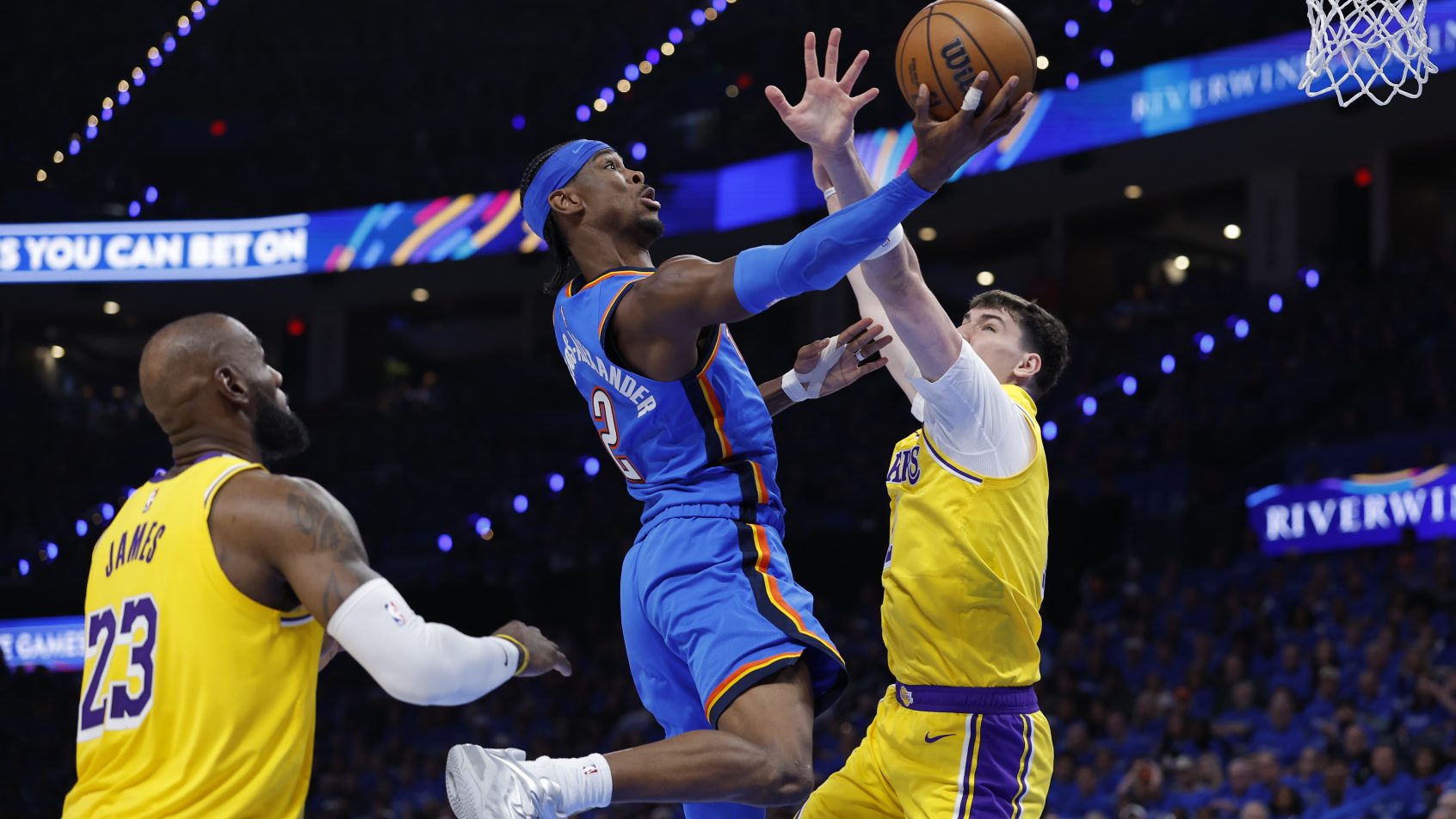 Shai Gilgeous-Alexander tries to score on LeBron James and the Lakers