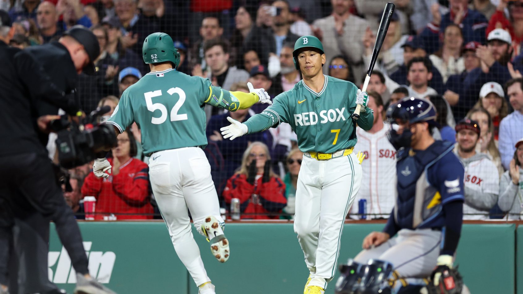 The Red Sox celebrate a run versus the Phillies.