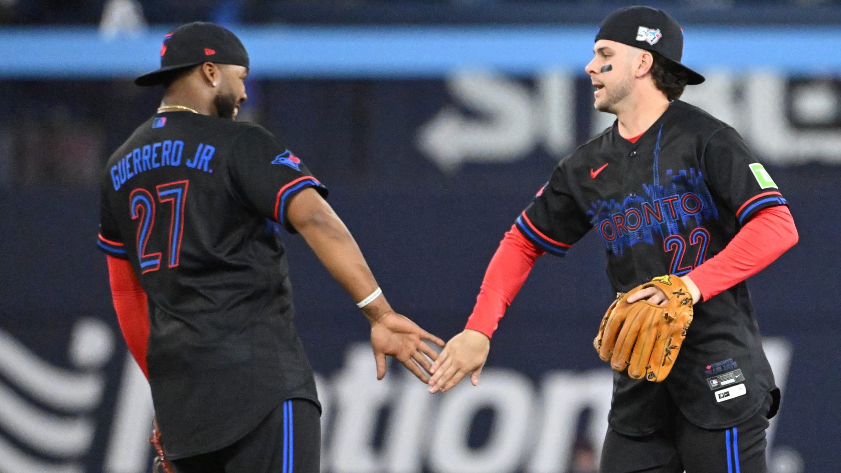 Ernie Clement and first baseman Vladimir Guerrero celebrate a win