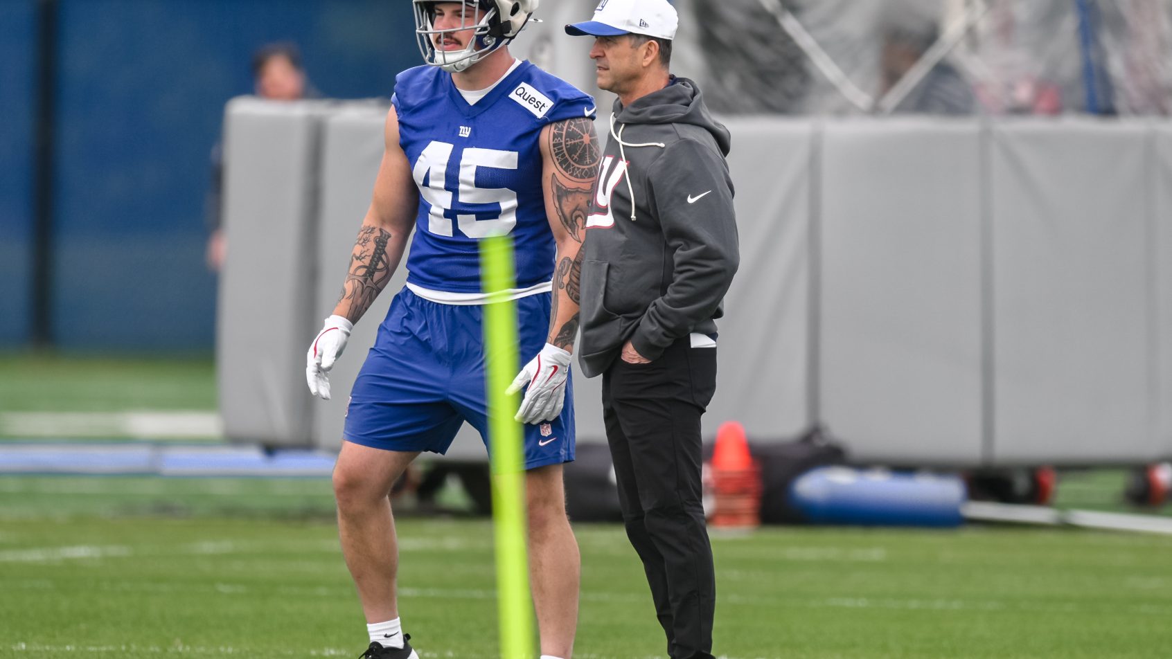 New York Giants head coach Jim Harbaugh talks with running back Grant Finley
