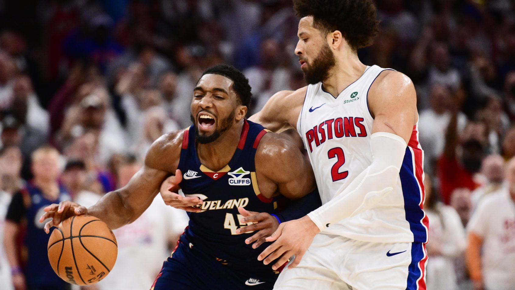 Detroit Pistons guard Cade Cunningham fouling Cleveland Cavaliers guard Donovan Mitchell