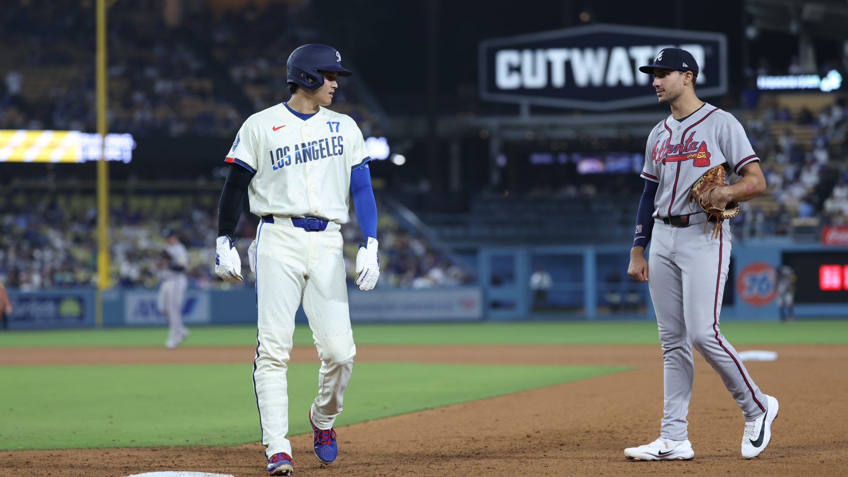 Los Angeles Dodgers two-way player Shohei Ohtani looking at Atlanta Braves first baseman Matt Olson