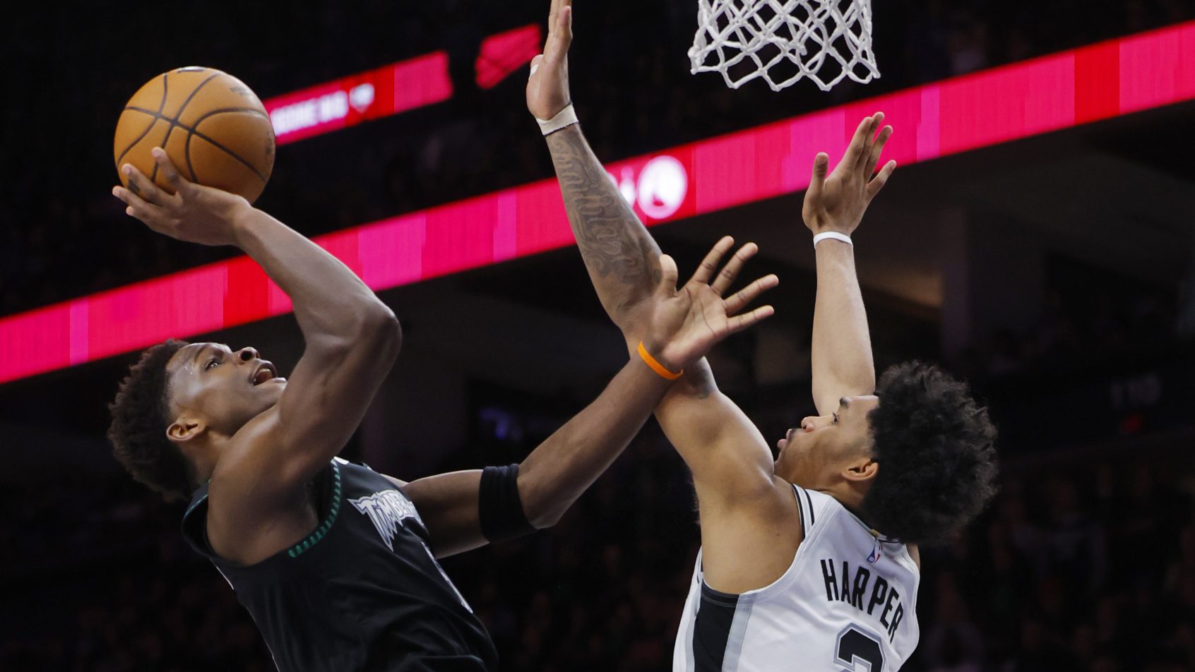 Anthony Edwards goes up for a contested shot in a playoff game versus the Spurs.