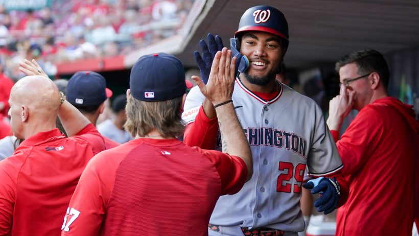 James Wood celebrates in the Nationals dugout with his teammates.