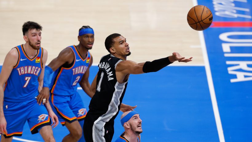 Victor Wembanyama reaches for a rebound during a playoff game versus the Thunder.