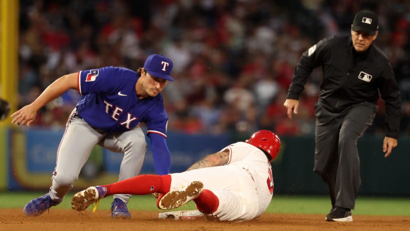 Texas Rangers second baseman Justin Foscue tags out Los Angeles Angels shortstop Zach Neto