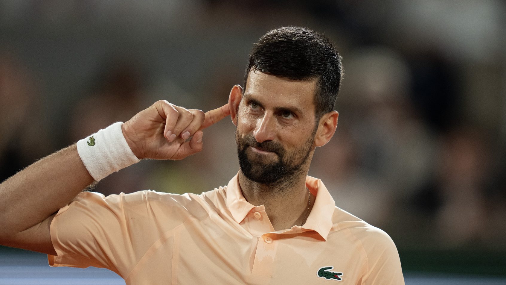 Novak Djokovic gestures to the crowd