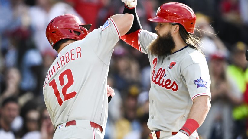 Brandon Marsh congratulates designated hitter Kyle Schwarber