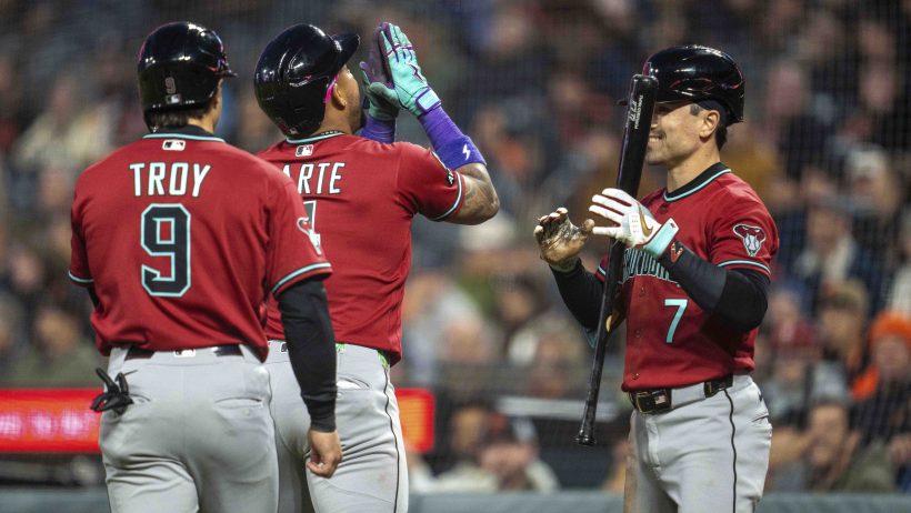 The Arizona Diamondbacks celebrate at home plate versus the San Francisco Giants.