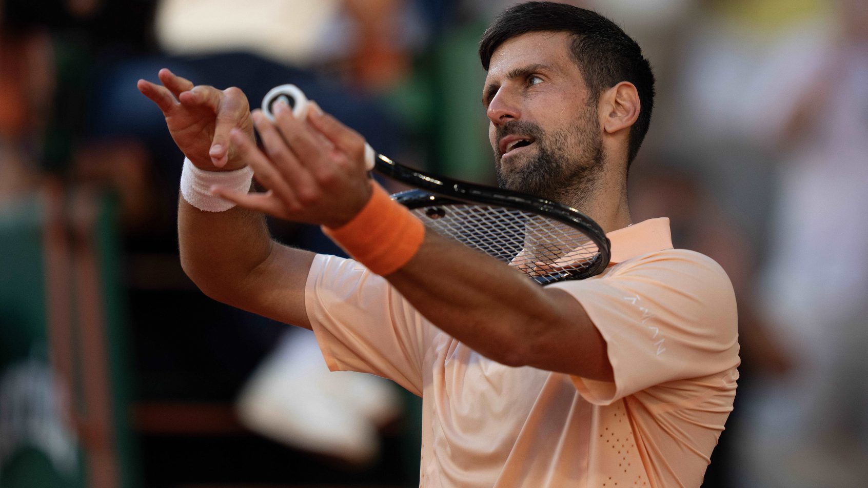 Novak Djokovic pretending his racket is a violin