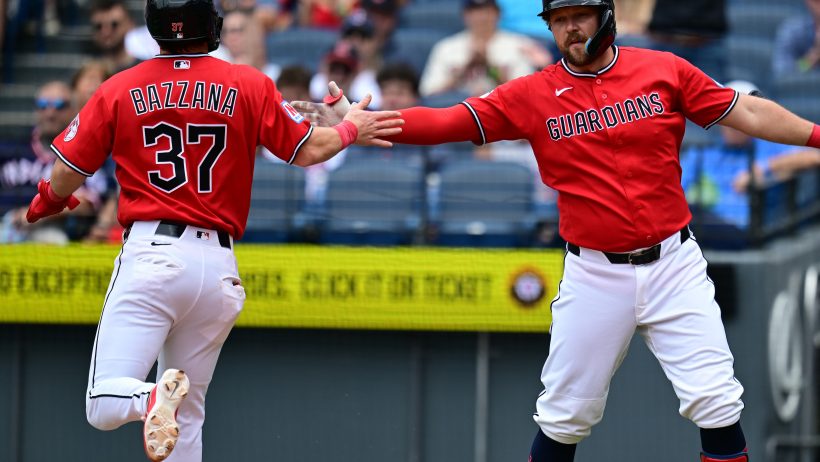 The Guardians celebrate scoring a run versus the Nationals.