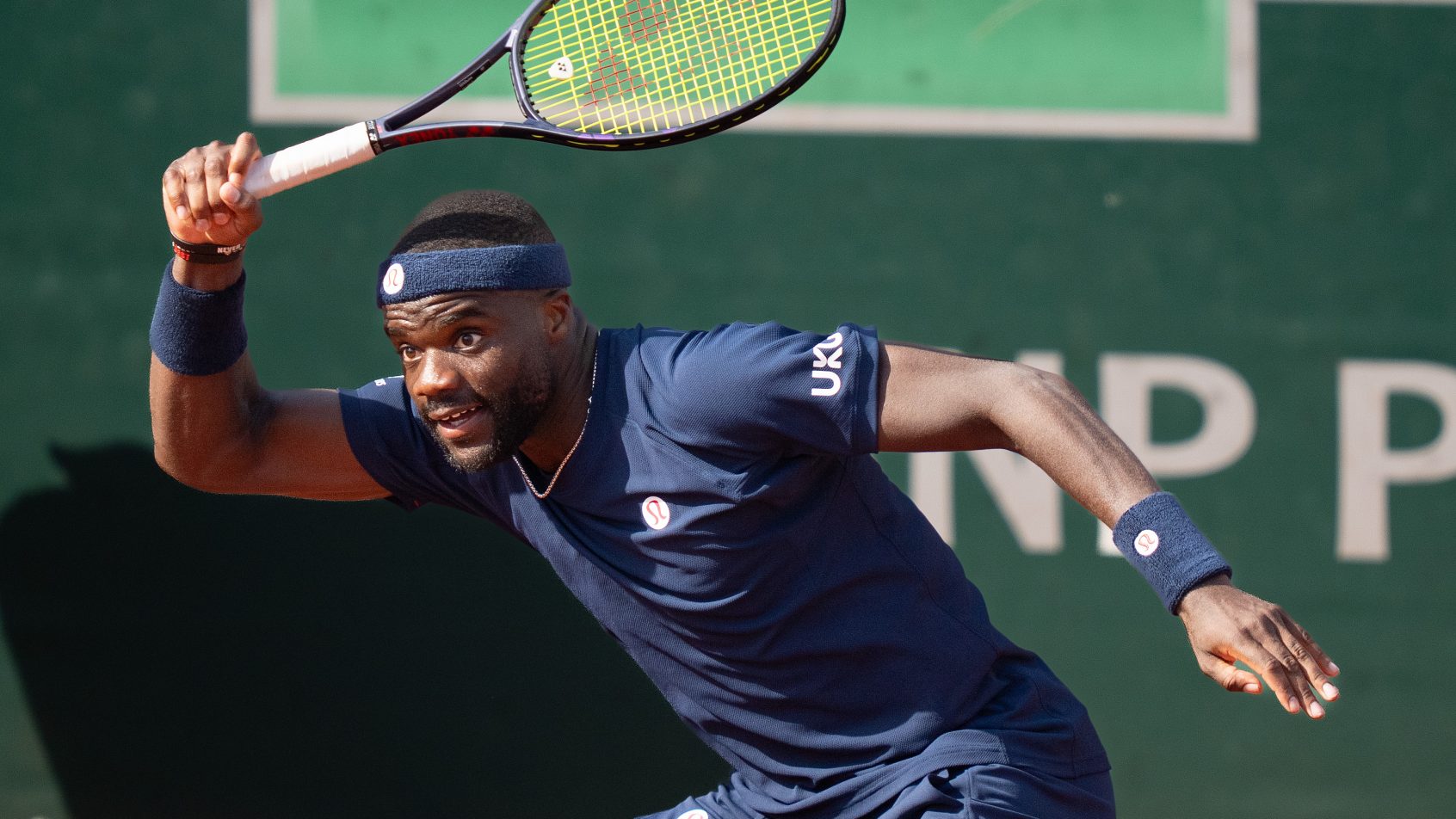 Frances Tiafoe hitting a forehand