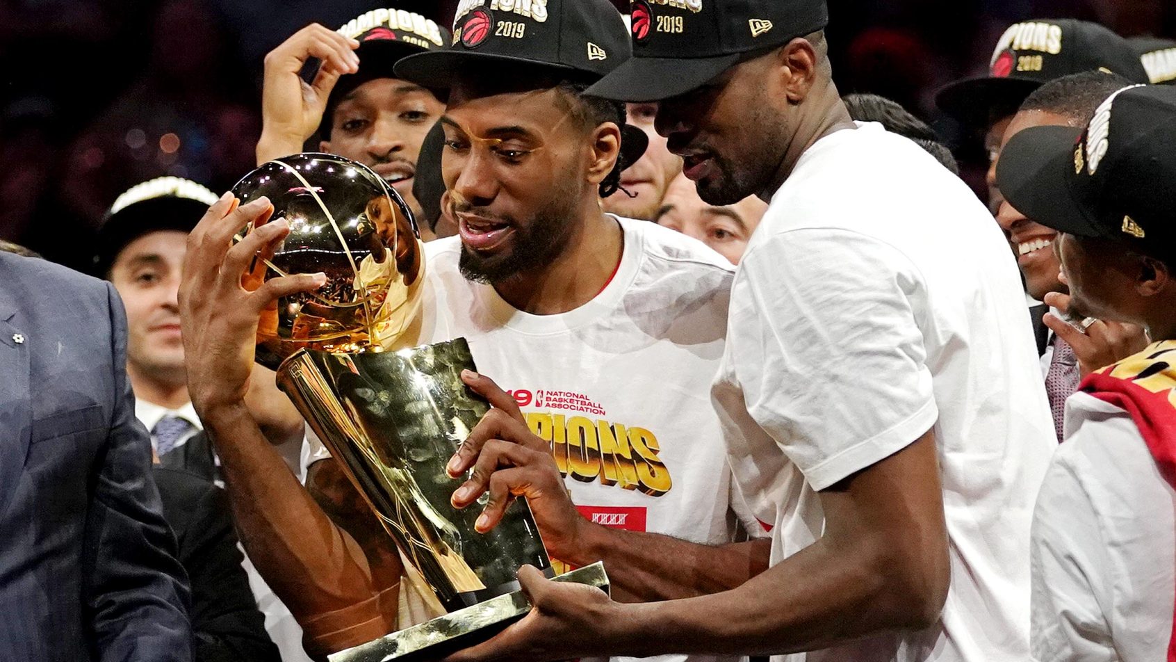 Toronto Raptors forward Kawhi Leonard and Toronto Raptors center Serge Ibaka celebrate with the Larry O'Brien Trophy