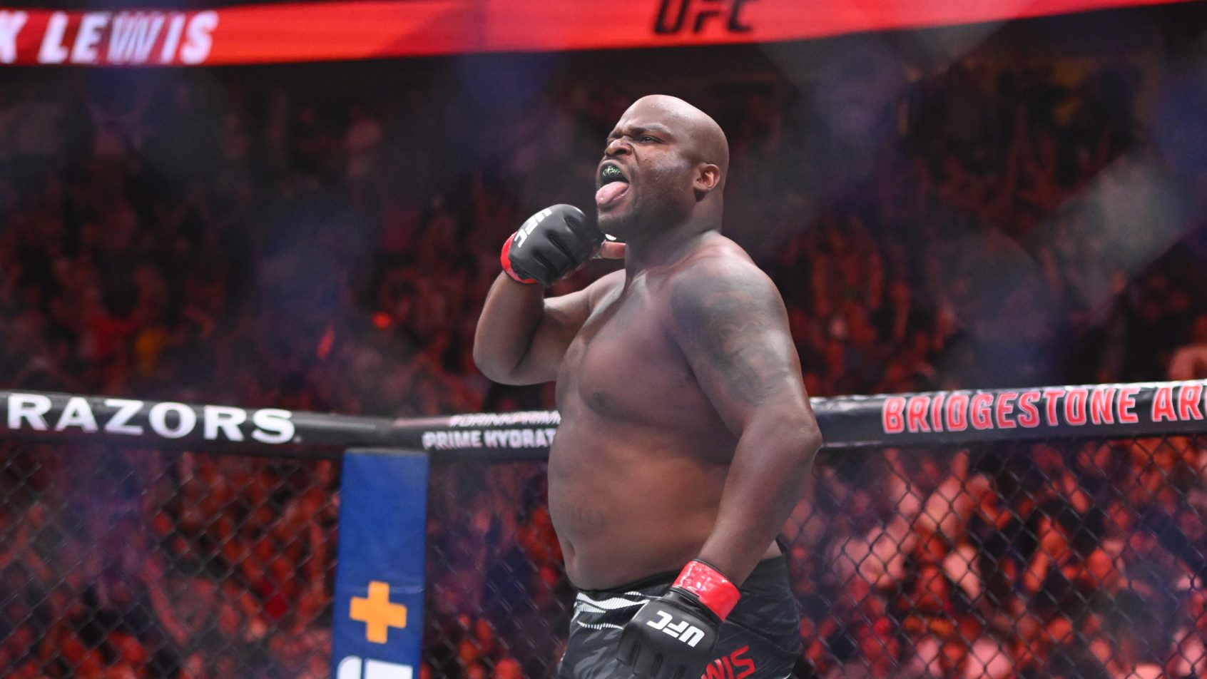 Jul 12, 2025; Nashville, Tennessee, United States; Derrick Lewis (red gloves) fights Tallison Teixeira (blue gloves) in a heavyweight bout during UFC Fight Night at Bridgestone Arena. Mandatory Credit: Steve Roberts-Imagn Images
