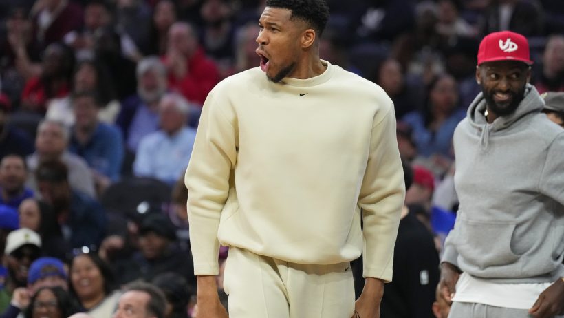 Milwaukee Bucks forward Giannis Antetokounmpo on the sideline in street clothes